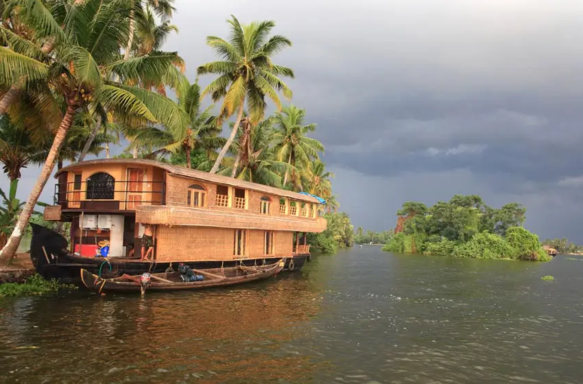Traditional kerala houseboat moored under palms